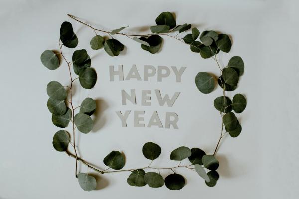 Happy New Year letters surrounded by Eucalyptus branches