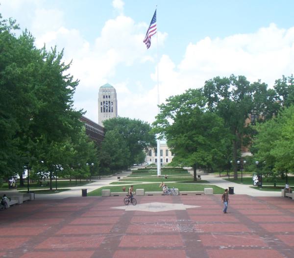 Ingalls Mall-South with the Diag open red brick paved space, with green trees, paved pathways, and people walking, riding a bicycle and sitting