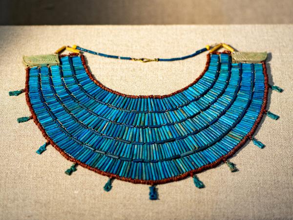 Bright-blue Egyptian broad-collar necklace made of strung beads of faience, glass, and ceramic.