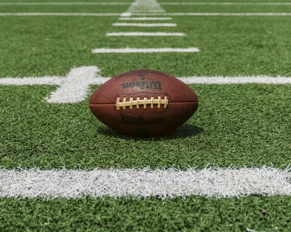 Football laying on a football field