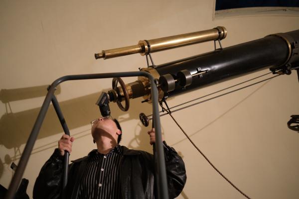 A visitor looks through the Fitz telescope