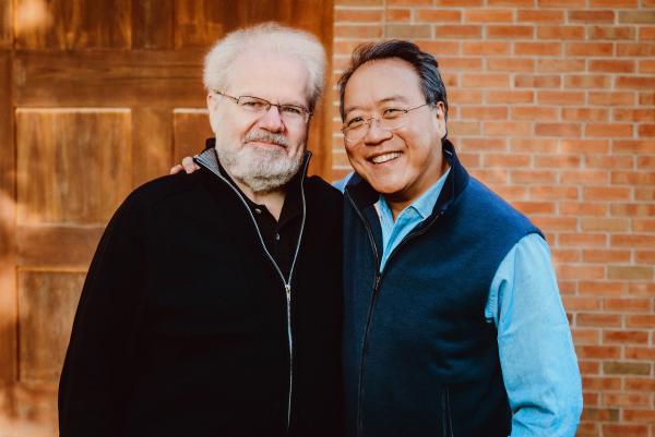 Emanuel Ax and Yo-Yo Ma standing in front of brick wall