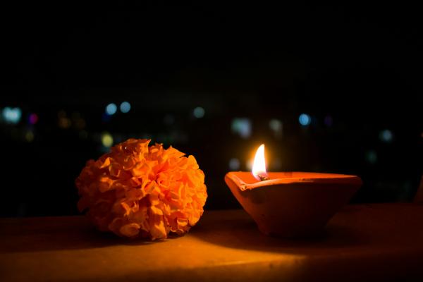 A marigold flower with a Diya