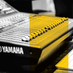 A Yamaha sound mixing board with a bold yellow overlay.