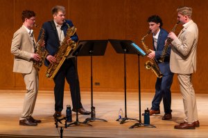 Chamber music group performs on stage.