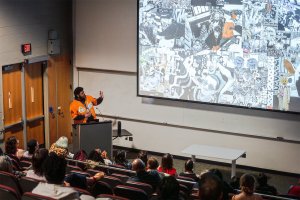 Michael King, Jr. Presents at a podium during the 2025 Meet the MFAs event