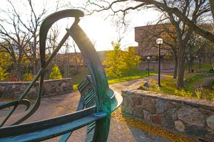 Walkway to the Moore Building at sunset in the fall, with a treble clef sculpture in the foreground.