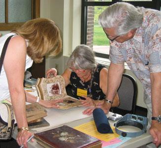 Leyla Lau Lamb, senior conservator at the U-M Library, examines a photo album an