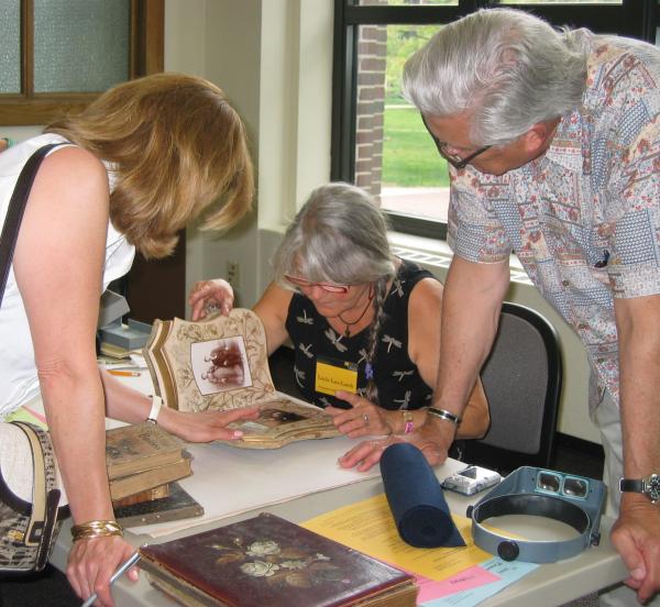 Leyla Lau Lamb, senior conservator at the U-M Library, examines a photo album an