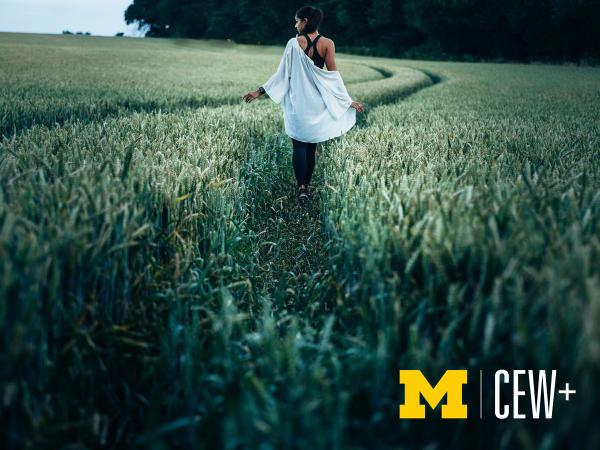 Photo of a woman standing in a grassy field