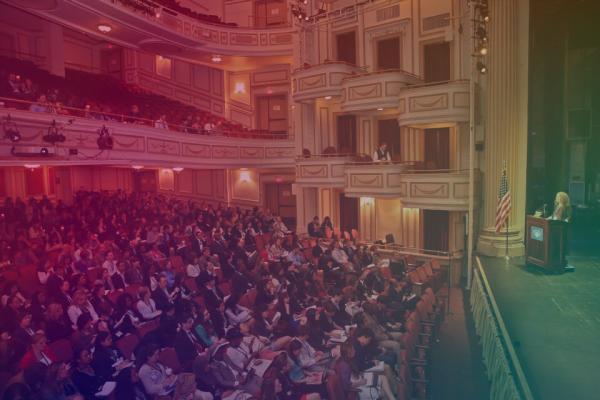 auditorium filled with people with a color gradient overlay