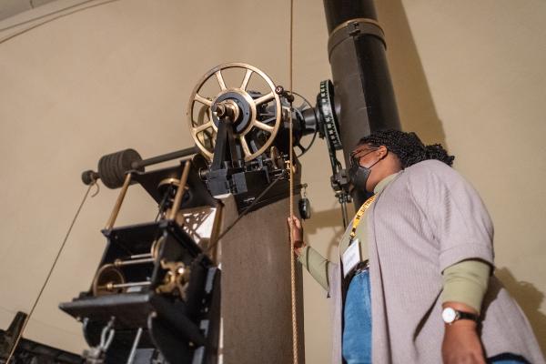 Image of a woman looking into a telescope.