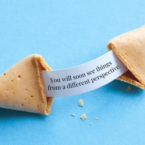 A fortune cookie is broken, revealing the message, "You will soon see things from a different perspective."