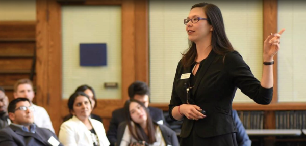 Student presenting in front of audience.