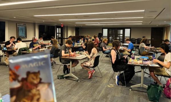 Image Imported from Maize Pages: Student sit in large classroom spaces at various tables playing games.